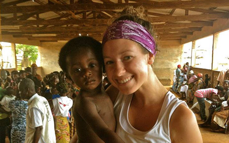 Dana Humphrey holding a child in Ghana.